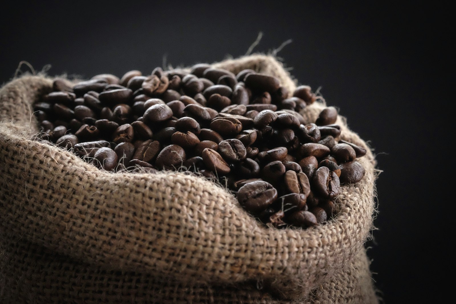 Three bags of subscription coffee tied with twine on a kitchen counter